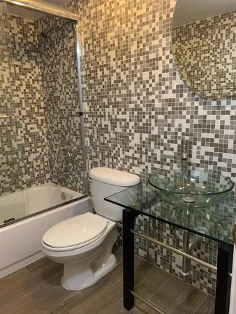 a white toilet sitting next to a shower curtain