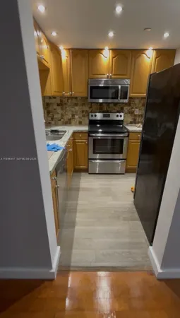 a kitchen with kitchen island a stove and a refrigerator
