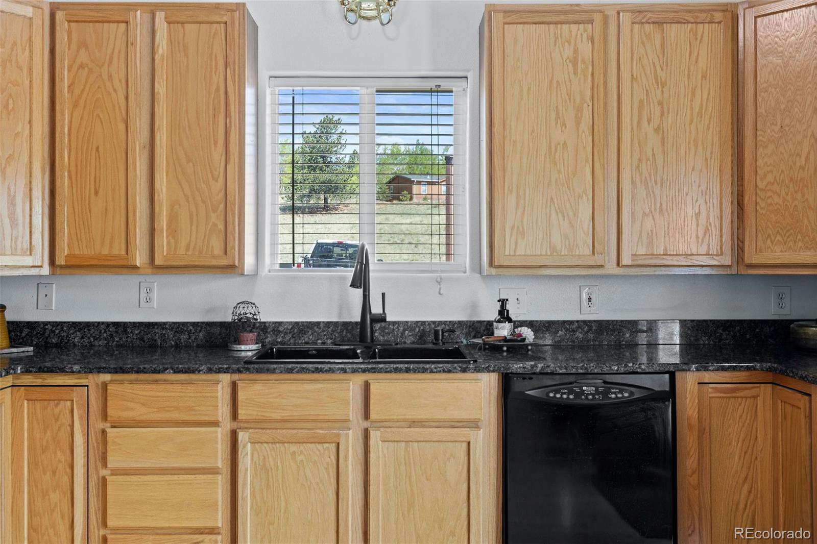 7551 Remington Road Como, CO 80432 - Photo 12 of 35 a kitchen with granite countertop white cabinets and sink