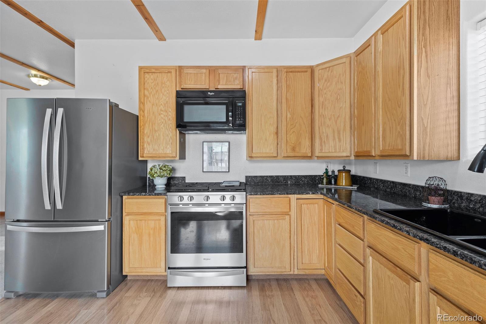 7551 Remington Road Como, CO 80432 - Photo 13 of 35 a kitchen with stainless steel appliances a stove microwave and refrigerator