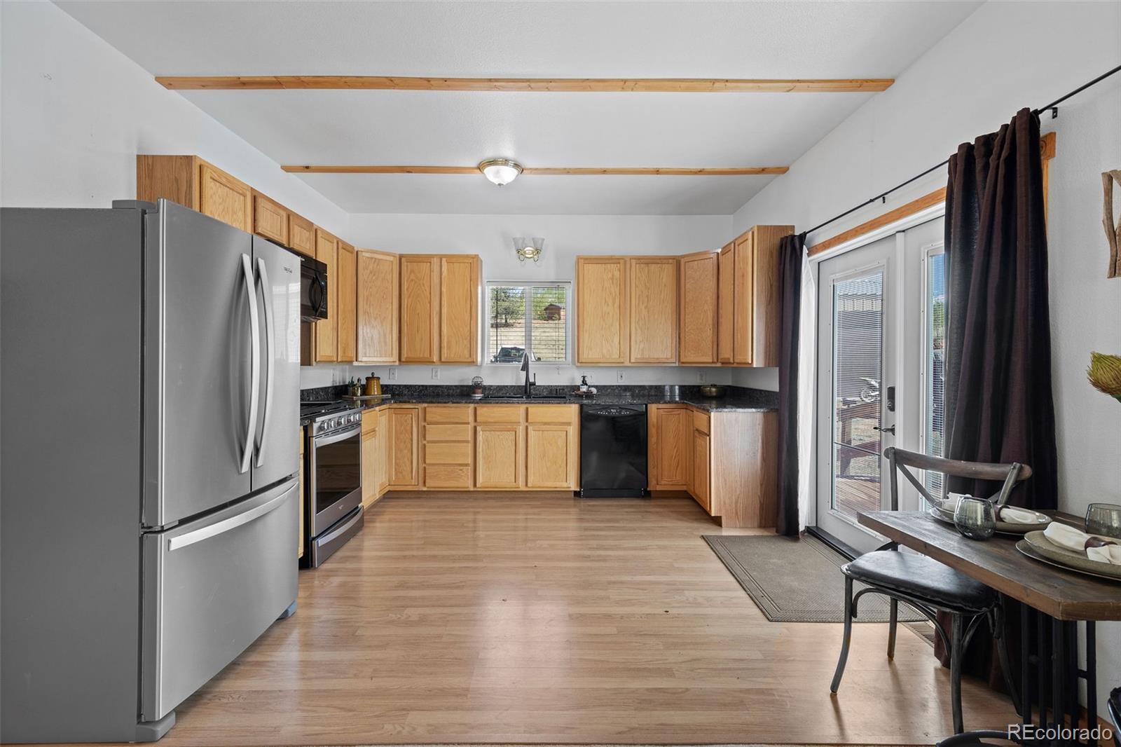 7551 Remington Road Como, CO 80432 - Photo 15 of 35 a kitchen with granite countertop a refrigerator stove top oven and sink