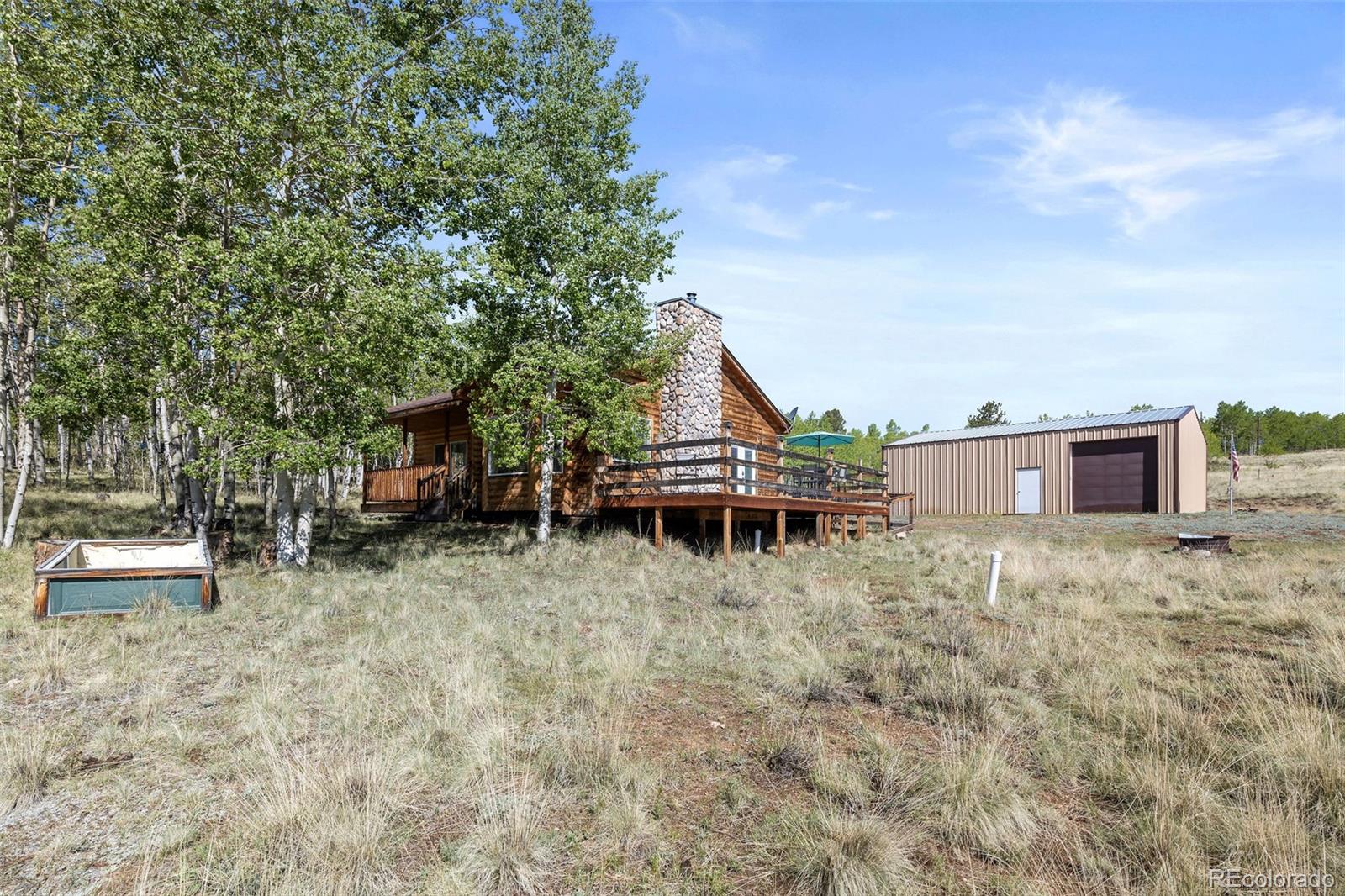 7551 Remington Road Como, CO 80432 - Photo 23 of 35 a house with trees in the background