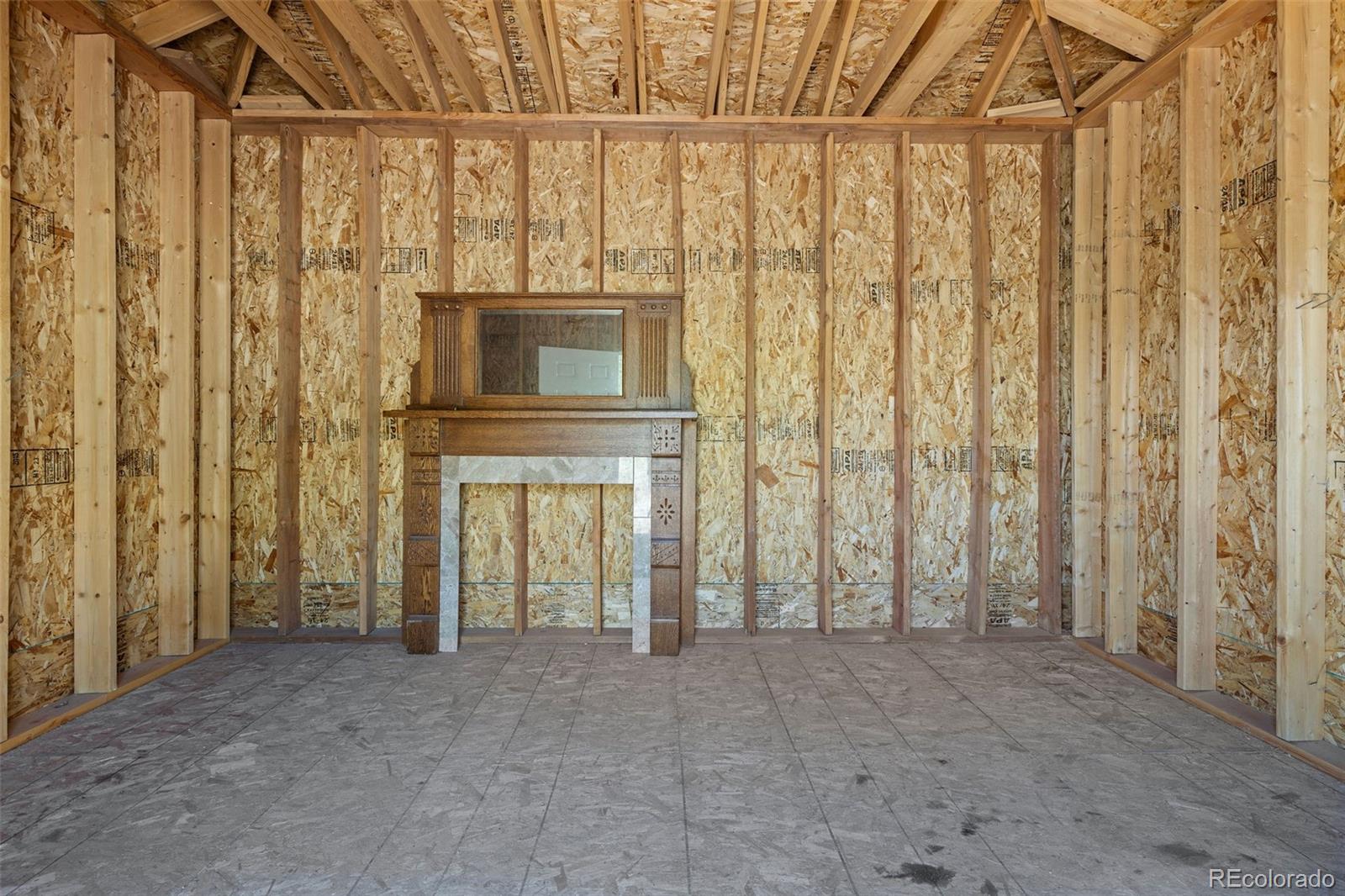 7551 Remington Road Como, CO 80432 - Photo 31 of 35 a view of an empty room with a fireplace and a window