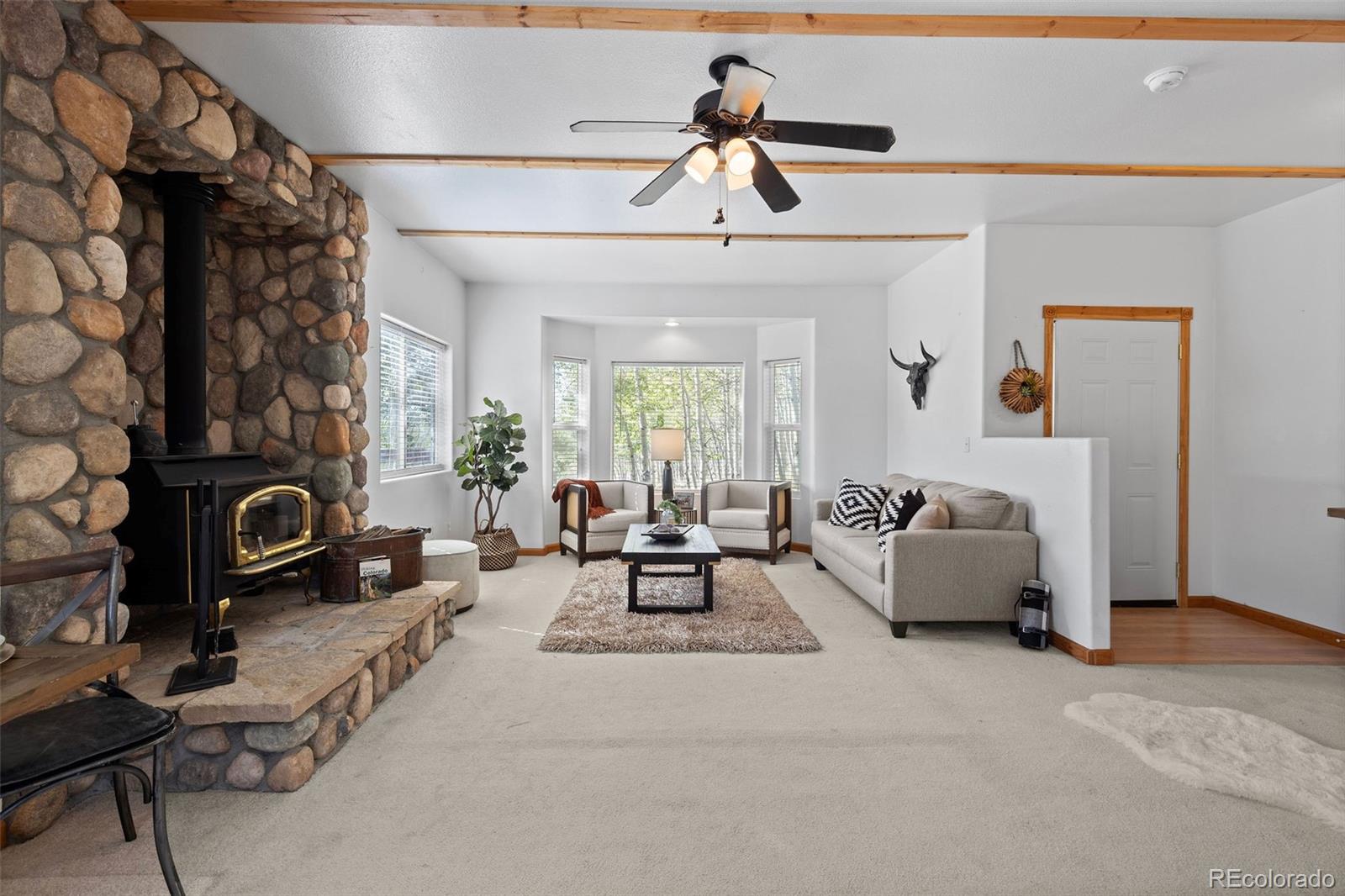 7551 Remington Road Como, CO 80432 - Photo 10 of 35 a living room with furniture and a fireplace