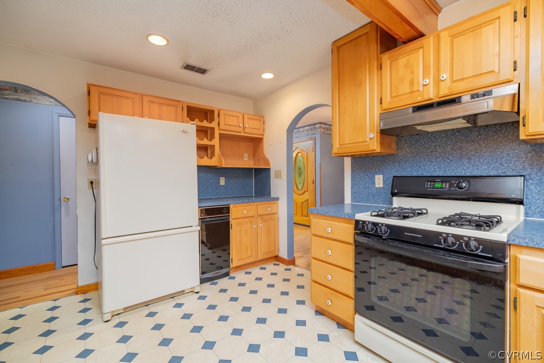 1218 Hardy Road Lunenburg, VA 23952 - Photo 8 of 35 a kitchen with stainless steel appliances granite countertop a refrigerator a stove and a sink