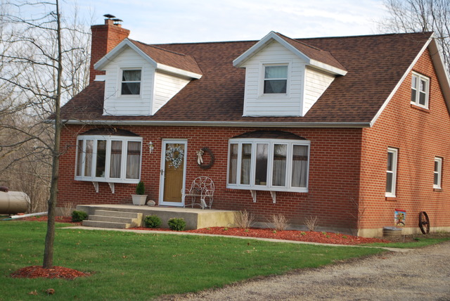 4255 East Flagg Road Ashton, IL 61006 - Photo 1 of 25 a front view of a house with a yard