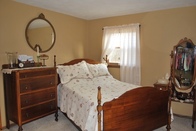 4255 East Flagg Road Ashton, IL 61006 - Photo 9 of 25 a bedroom with a bed and a mirror