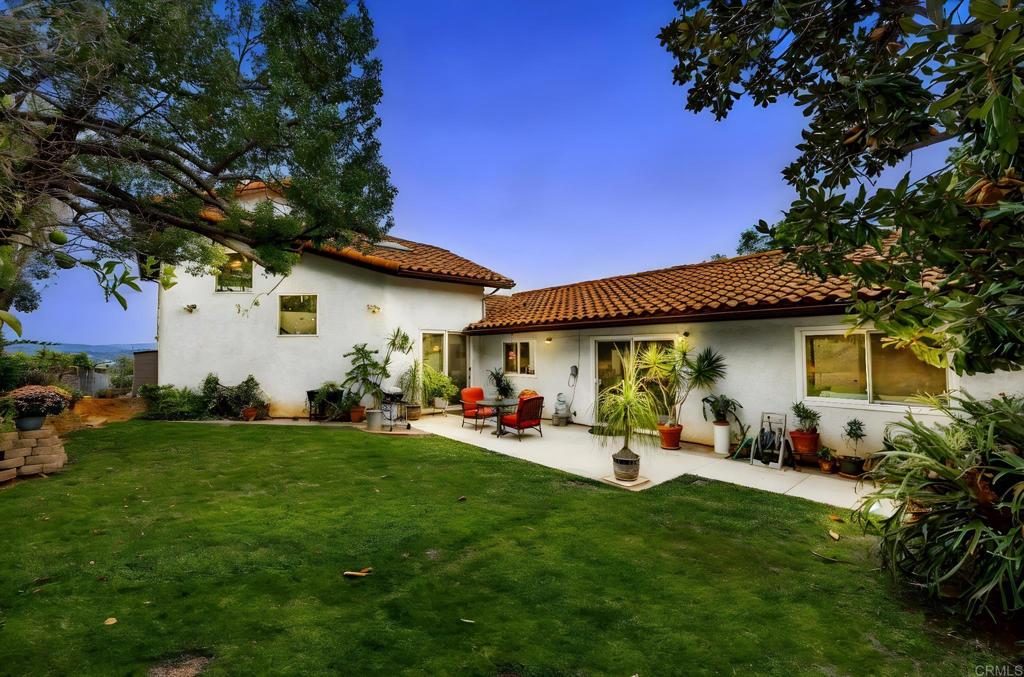 1402 Rimrock Drive Escondido, CA 92027 - Photo 11 of 69 a view of a backyard with plants and a large tree