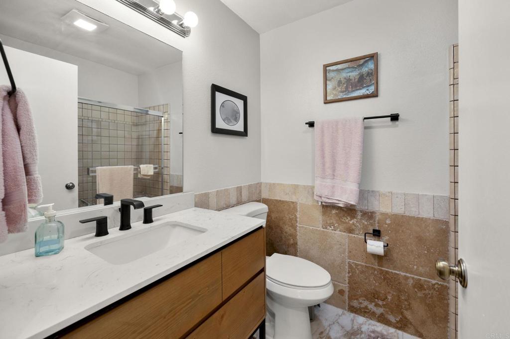 1402 Rimrock Drive Escondido, CA 92027 - Photo 28 of 69 a bathroom with a sink toilet and mirror