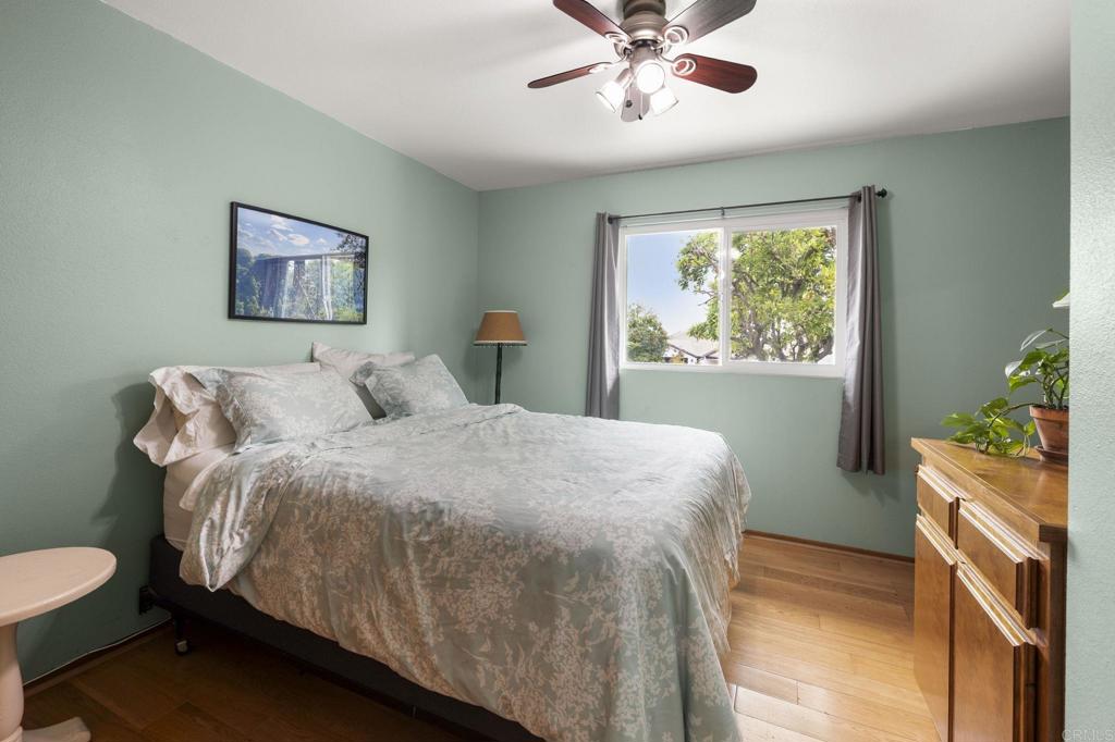 1402 Rimrock Drive Escondido, CA 92027 - Photo 29 of 69 a bedroom with a bed and a chandelier