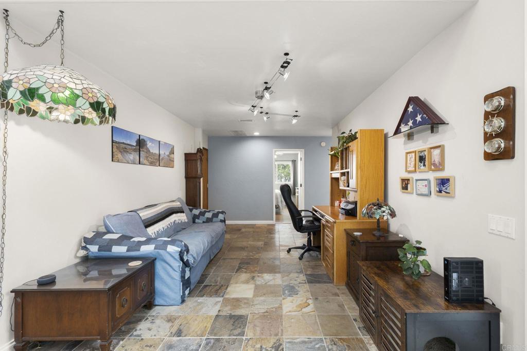 1402 Rimrock Drive Escondido, CA 92027 - Photo 30 of 69 a living room with furniture and a chandelier