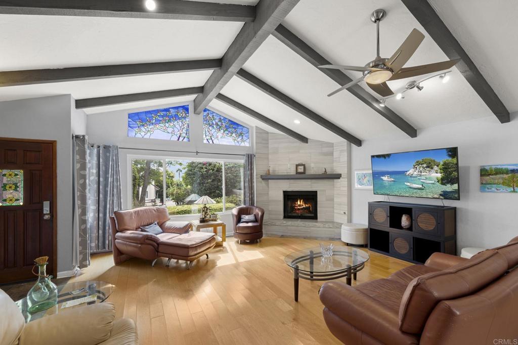 1402 Rimrock Drive Escondido, CA 92027 - Photo 3 of 69 a living room with furniture a fireplace and a flat screen tv