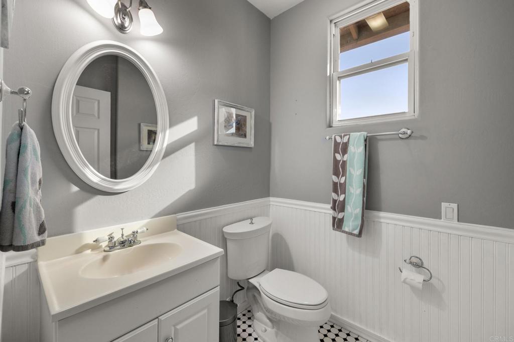 1402 Rimrock Drive Escondido, CA 92027 - Photo 40 of 69 a bathroom with a toilet sink and mirror
