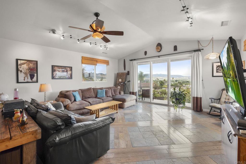 1402 Rimrock Drive Escondido, CA 92027 - Photo 46 of 69 a living room with furniture a flat screen tv and a large window