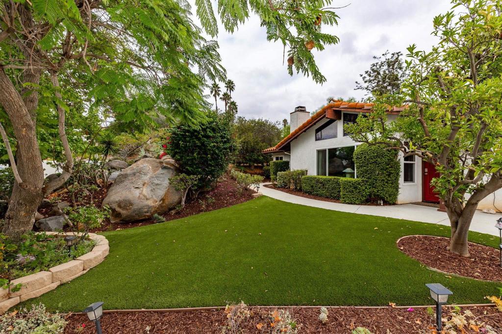 1402 Rimrock Drive Escondido, CA 92027 - Photo 66 of 69 a front view of a house with a garden and tree