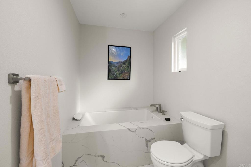 1402 Rimrock Drive Escondido, CA 92027 - Photo 7 of 69 a white toilet sitting next to a bath tub