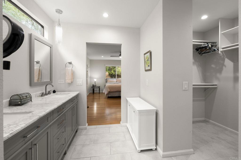 1402 Rimrock Drive Escondido, CA 92027 - Photo 8 of 69 a spacious bathroom with a granite countertop sink a mirror and shower