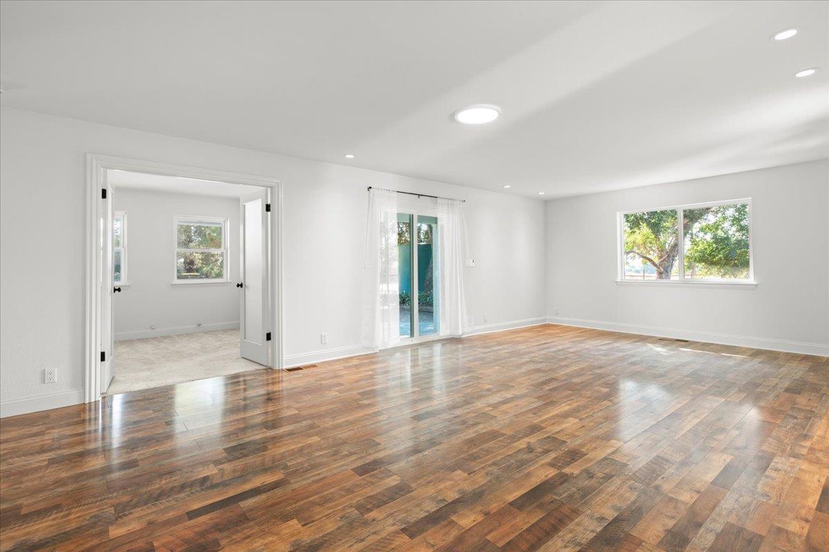 3306 Leavesley Road Gilroy, CA 95020 - Photo 14 of 60 a view of an empty room with wooden floor and a window