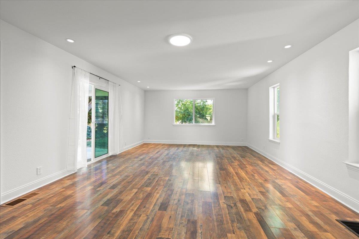 3306 Leavesley Road Gilroy, CA 95020 - Photo 16 of 60 an empty room with wooden floor and windows
