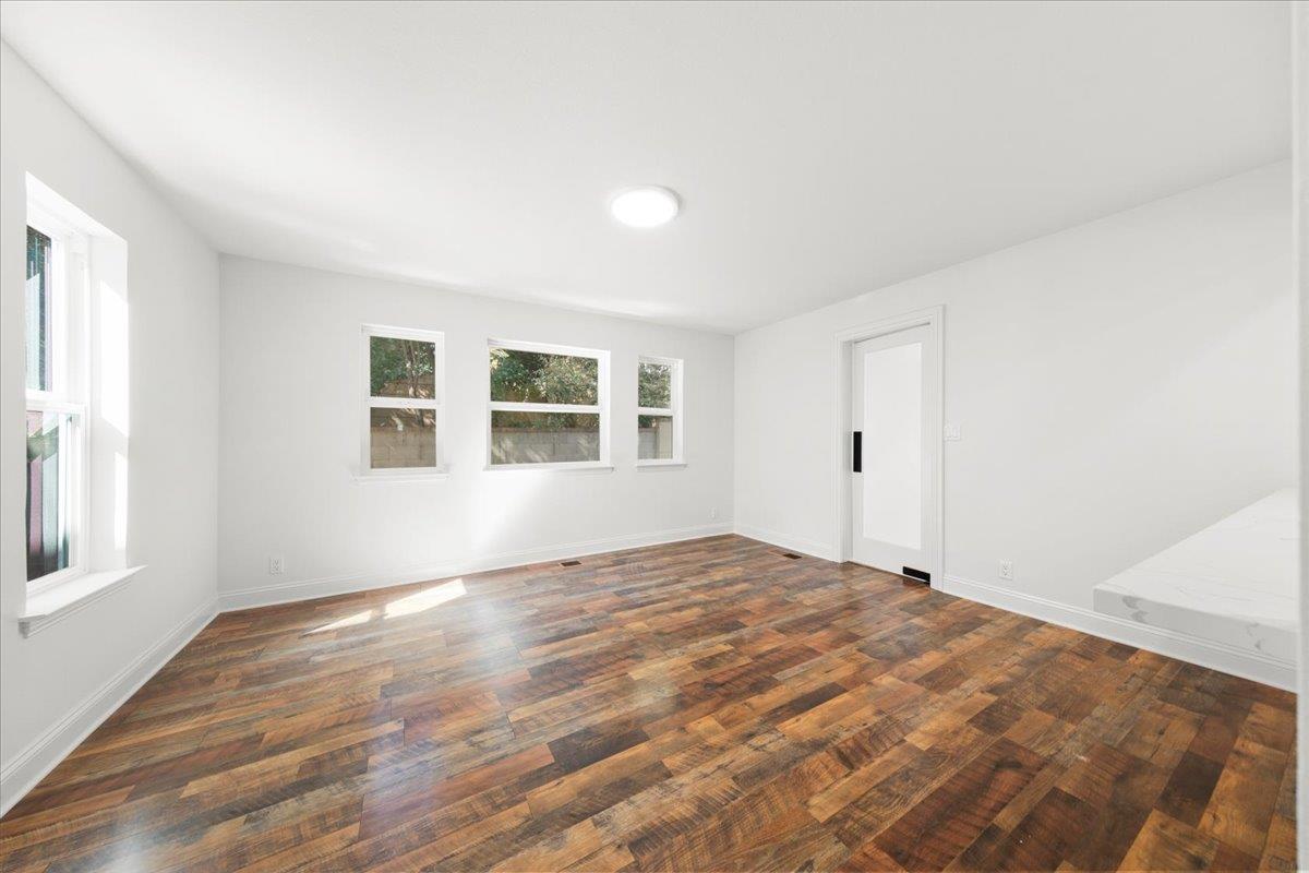 3306 Leavesley Road Gilroy, CA 95020 - Photo 27 of 60 a view of an empty room with wooden floor and a window