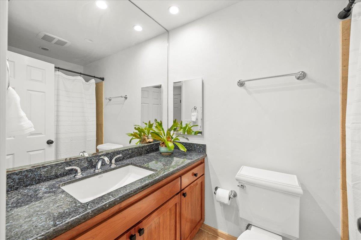 3306 Leavesley Road Gilroy, CA 95020 - Photo 38 of 60 a bathroom with a granite countertop sink and a mirror with toilet