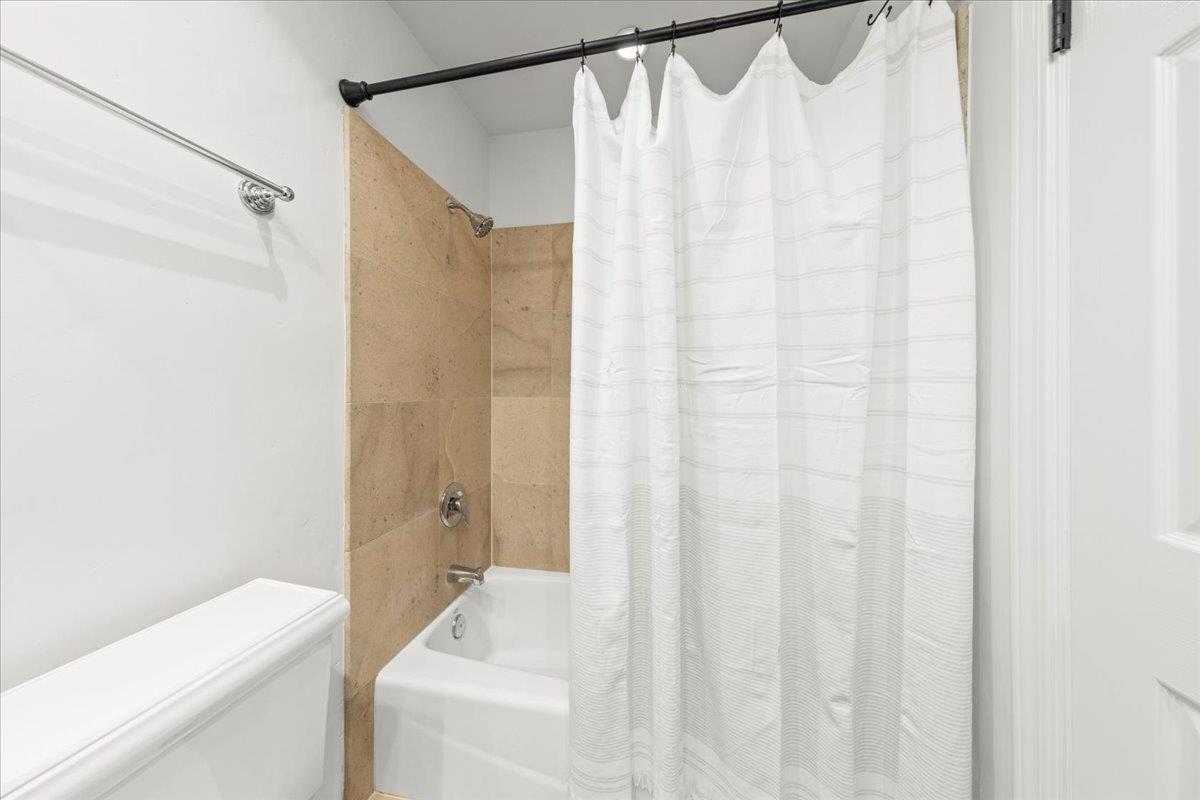 3306 Leavesley Road Gilroy, CA 95020 - Photo 39 of 60 a bathroom with a shower curtain and a sink