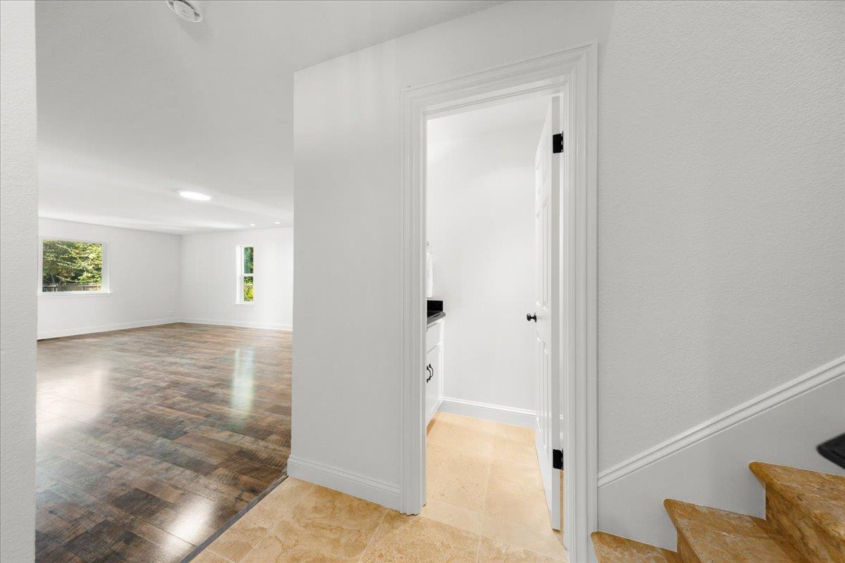 3306 Leavesley Road Gilroy, CA 95020 - Photo 7 of 60 a view of a hallway with wooden floor and a cabinet