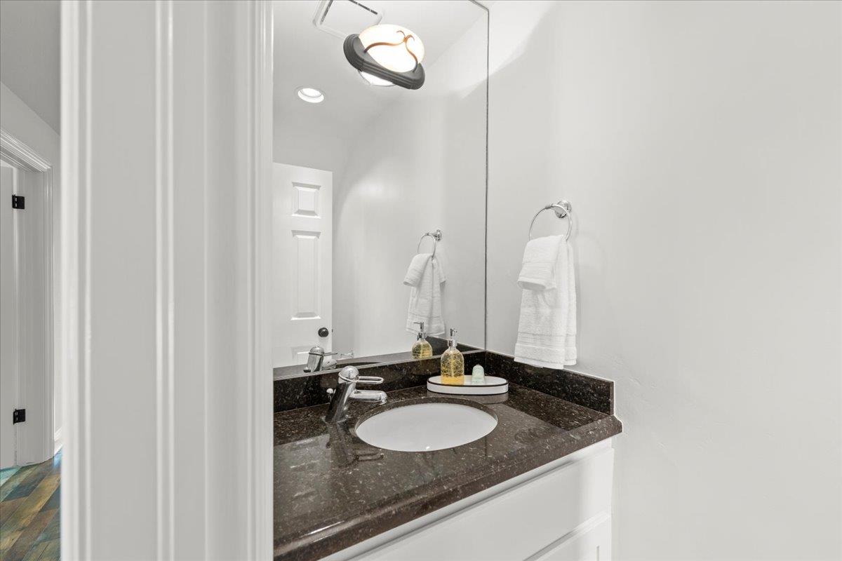 3306 Leavesley Road Gilroy, CA 95020 - Photo 8 of 60 a bathroom with a granite countertop sink and a mirror
