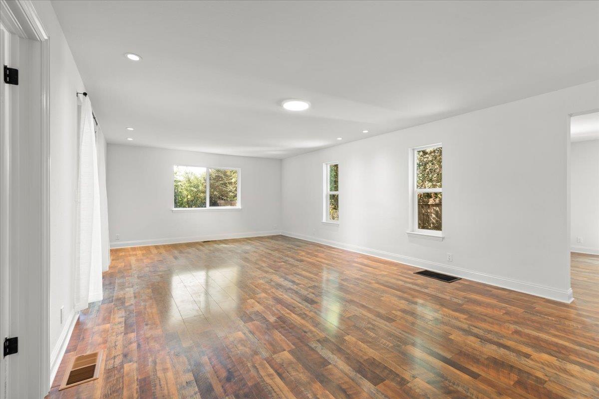 3306 Leavesley Road Gilroy, CA 95020 - Photo 9 of 60 an empty room with wooden floor and windows