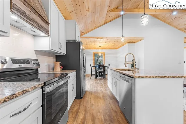a kitchen with a sink a stove and cabinets