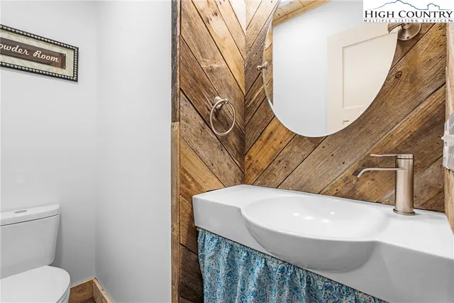 a bathroom with a sink a mirror and a toilet