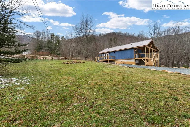 a view of a house with garden and sitting area