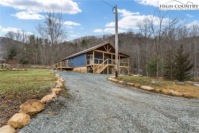 a view of house with backyard