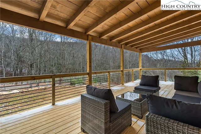 a balcony with wooden floor and furniture