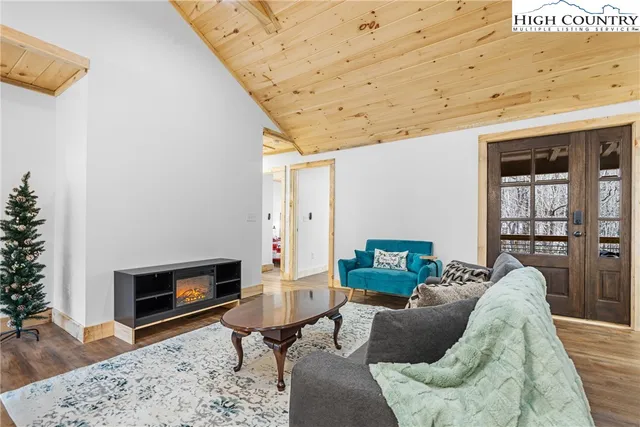 a living room with furniture a rug and a fireplace