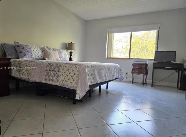 a bedroom with a bed and a table in it