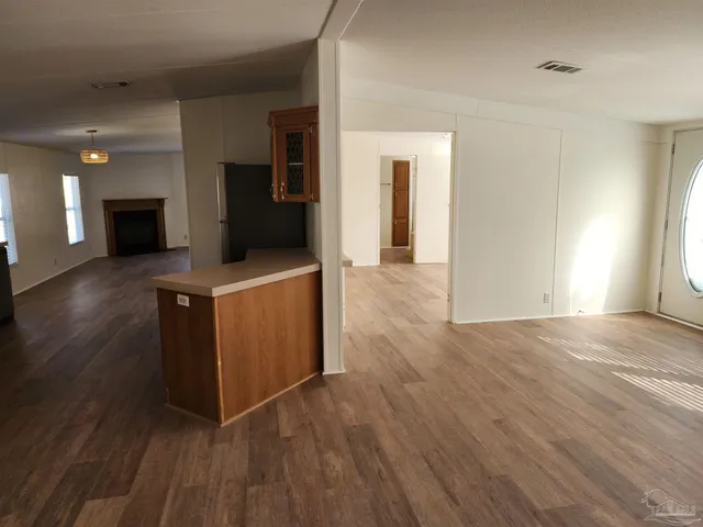 a view of a kitchen cabinets and a wooden floor