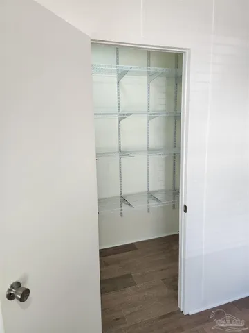 an empty room with cabinet and mirrors