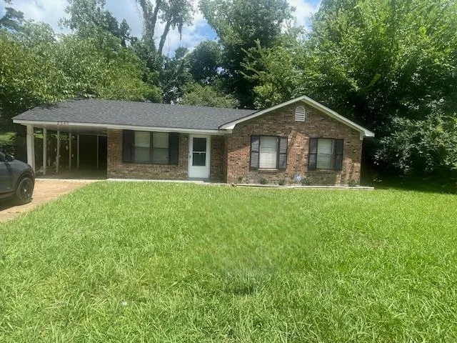 a front view of house with yard and green space
