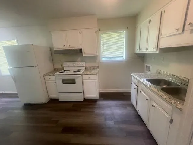 a kitchen with a stove a sink and a refrigerator