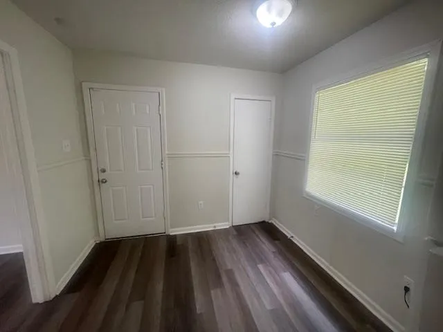 wooden floor in an empty room with a window