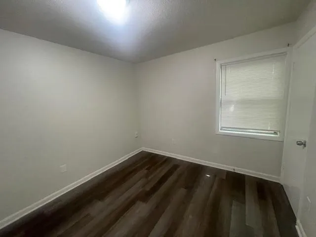 a view of a room with wooden floor and windows