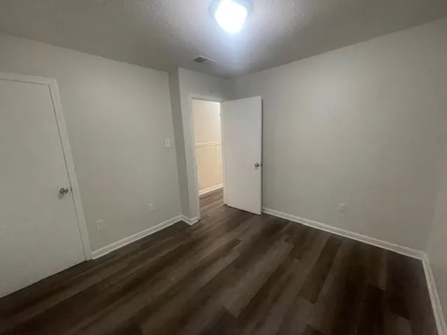 an empty room with wooden floor