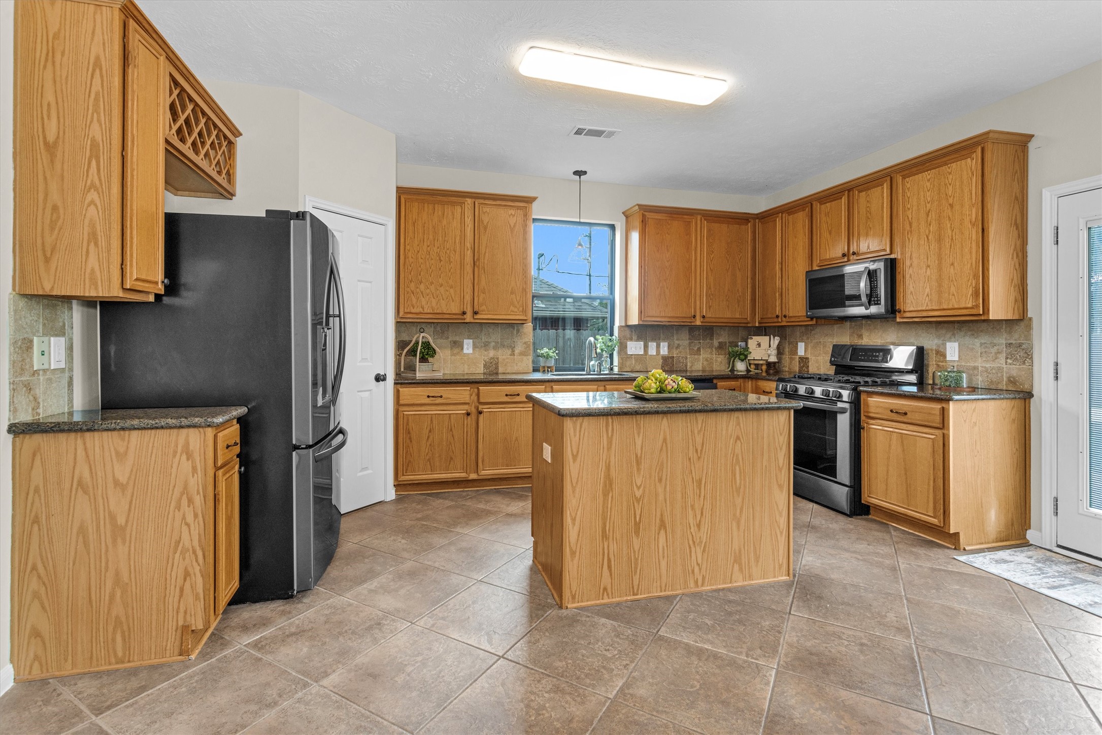 7419 Alderly Drive Spring, TX 77389 - Photo 15 of 49 a kitchen with stainless steel appliances granite countertop a stove top oven a refrigerator a sink and dishwasher