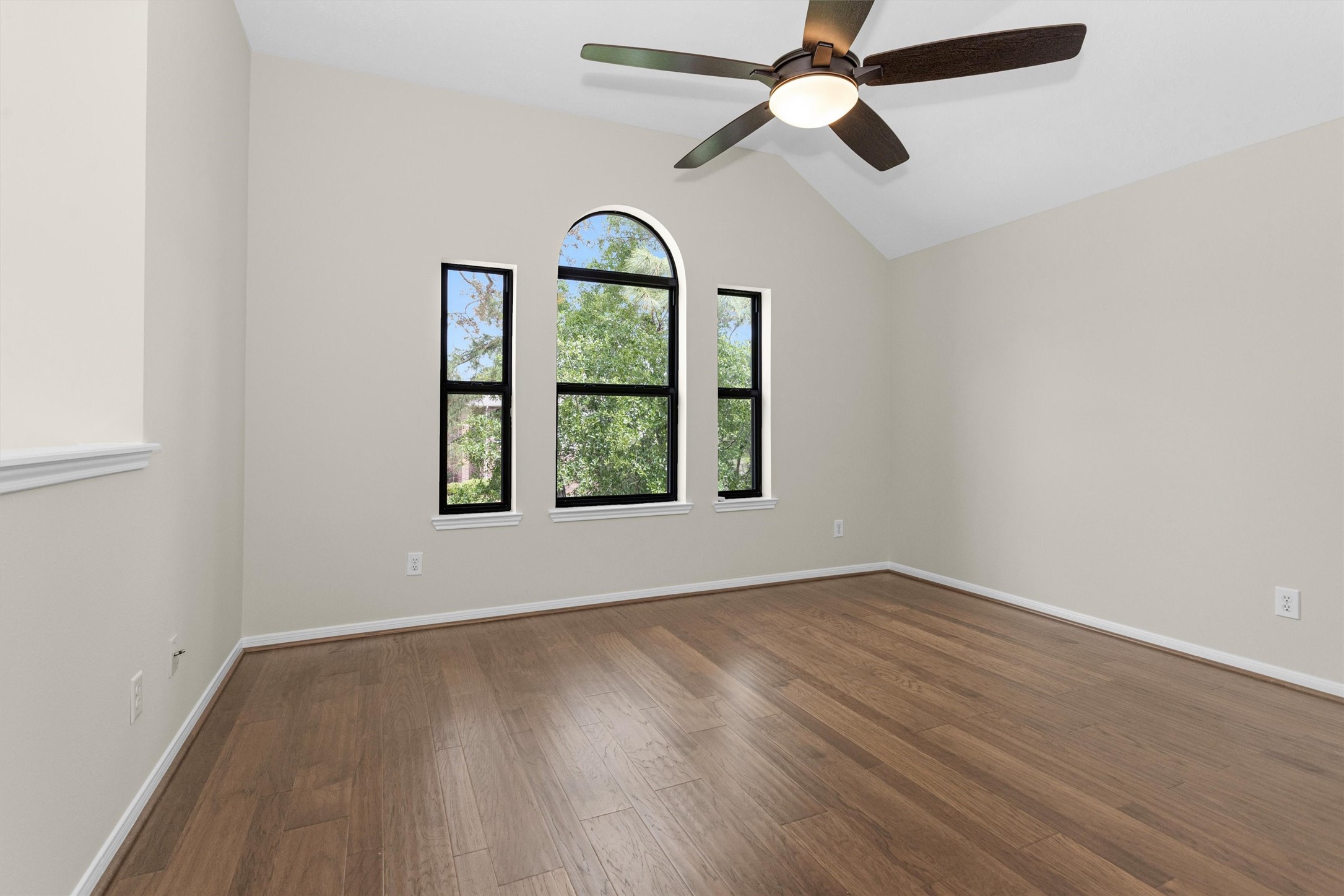 7419 Alderly Drive Spring, TX 77389 - Photo 19 of 49 an empty room with wooden floor chandelier and windows