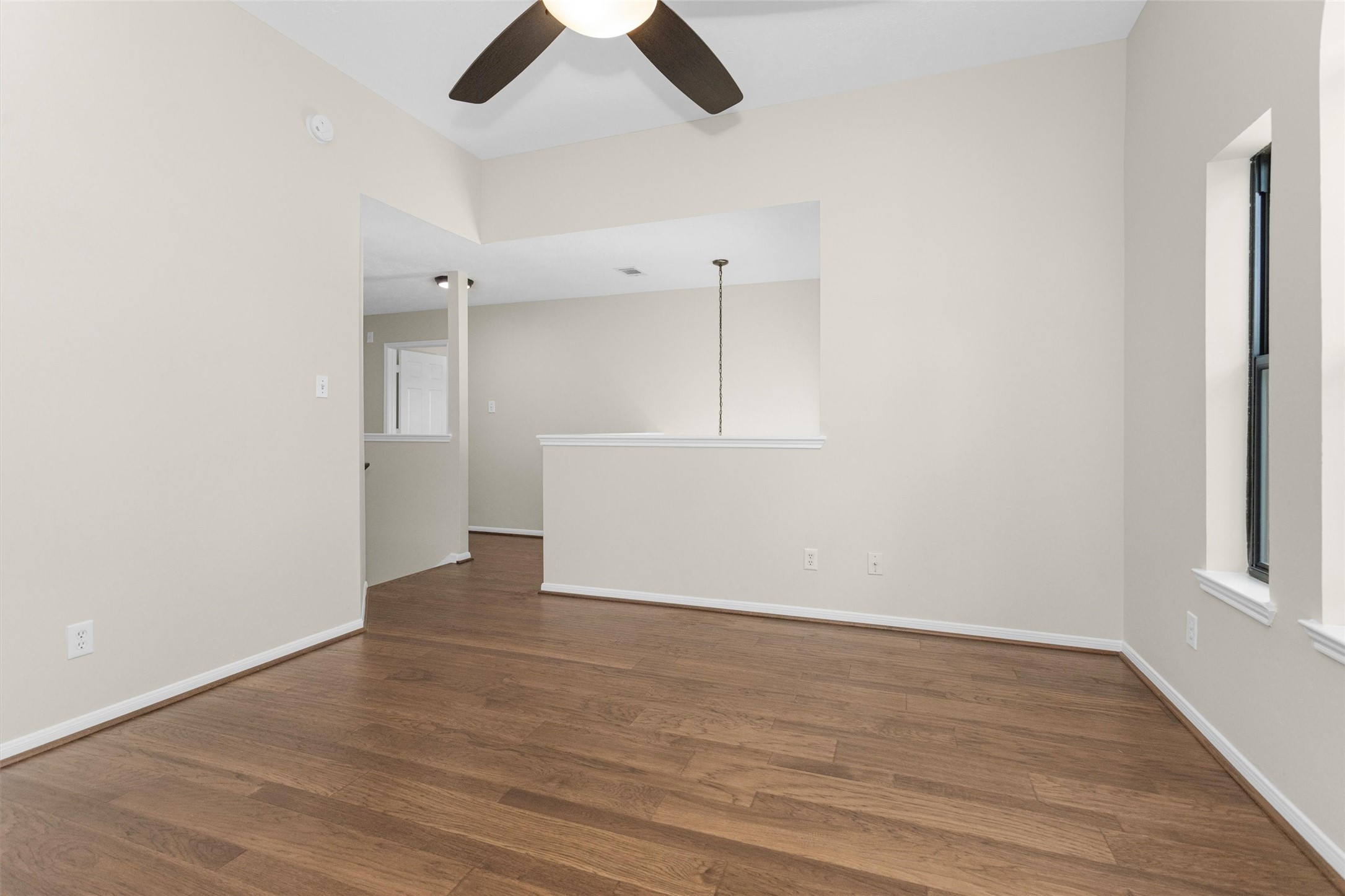 7419 Alderly Drive Spring, TX 77389 - Photo 20 of 49 an empty room with wooden floor cabinet and windows