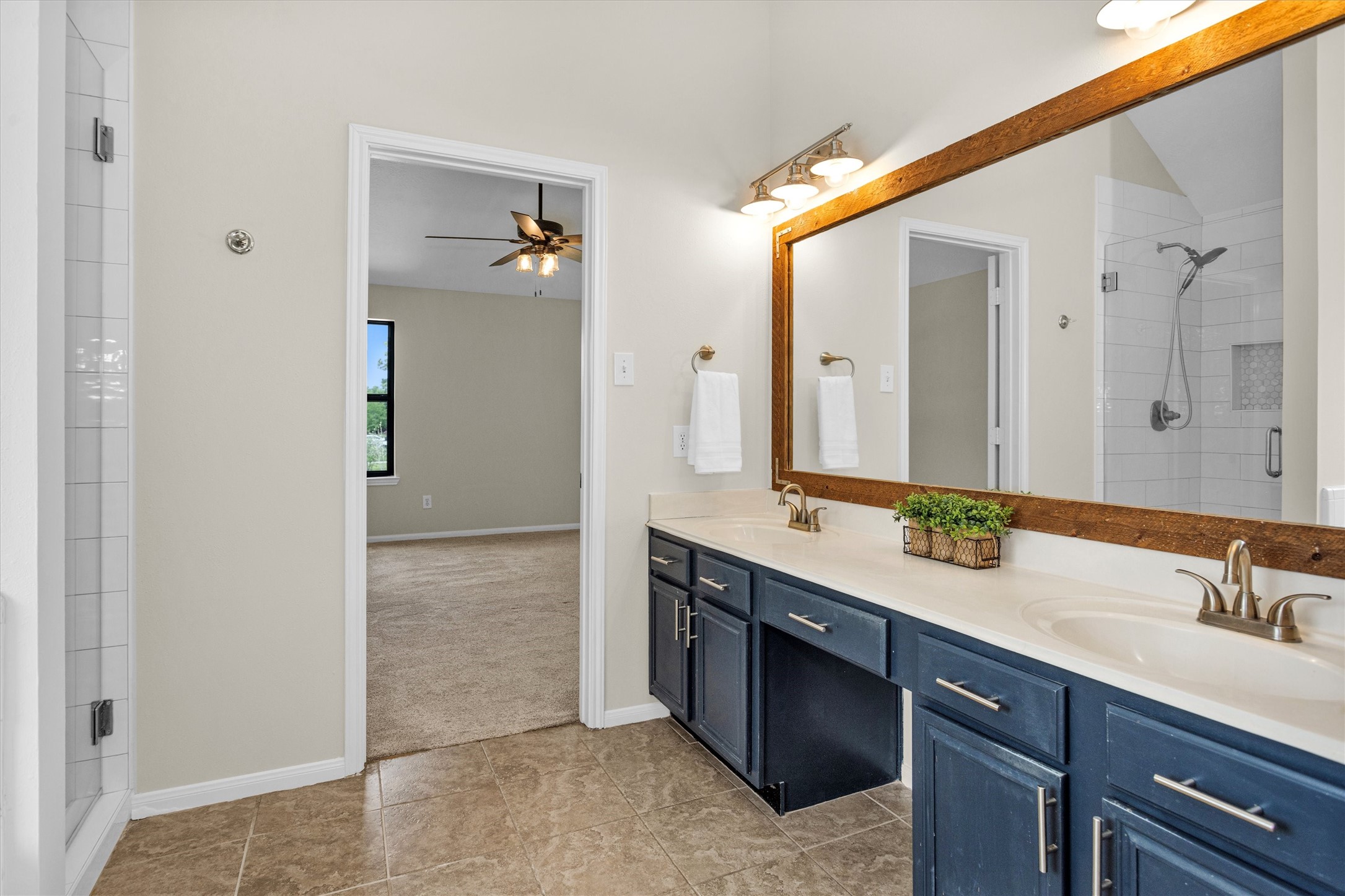 7419 Alderly Drive Spring, TX 77389 - Photo 27 of 49 a bathroom with a double vanity sink and mirror