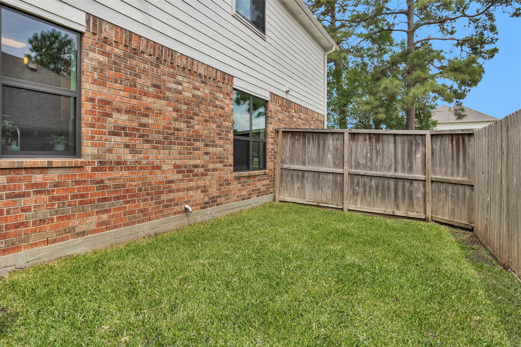 7419 Alderly Drive Spring, TX 77389 - Photo 42 of 49 a view of backyard with wooden fence and a bench