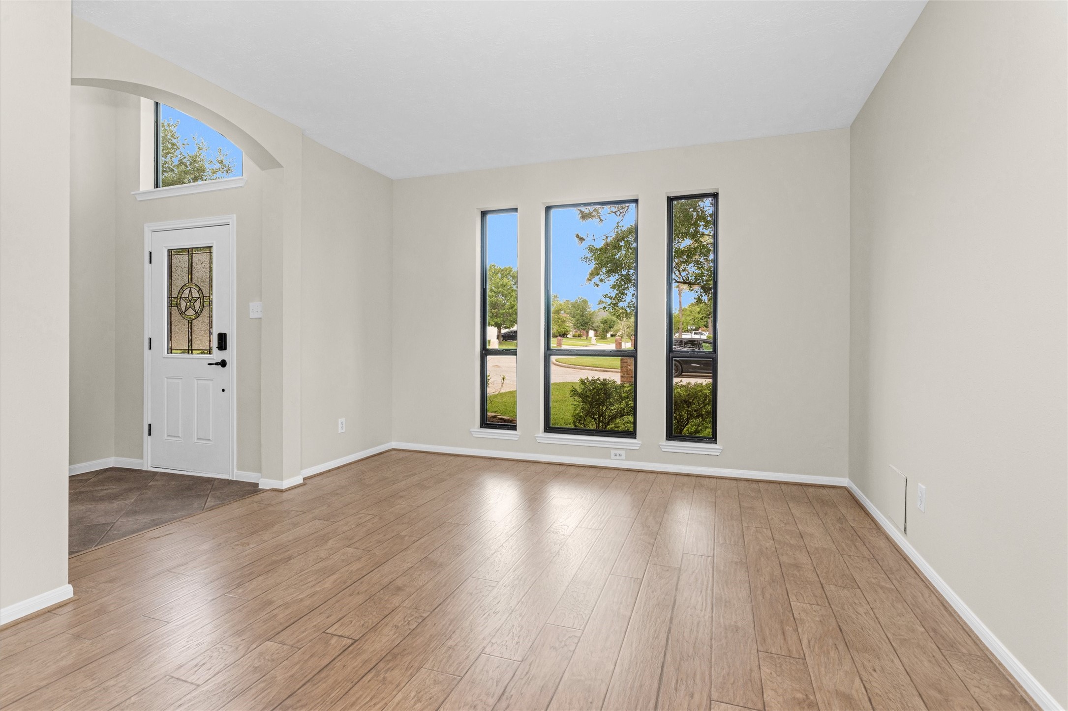 7419 Alderly Drive Spring, TX 77389 - Photo 7 of 49 an empty room with wooden floor and windows