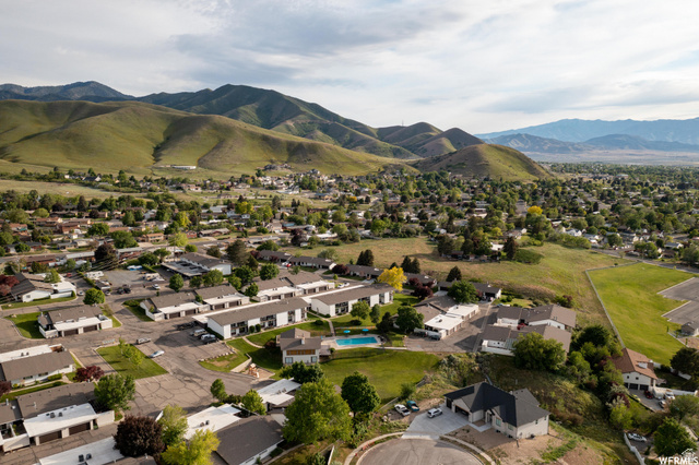 34 Benchmark Village Tooele, UT 84074 - Photo 30 of 35 Aerial perspective of suburban area featuring a mountainous background and a pool